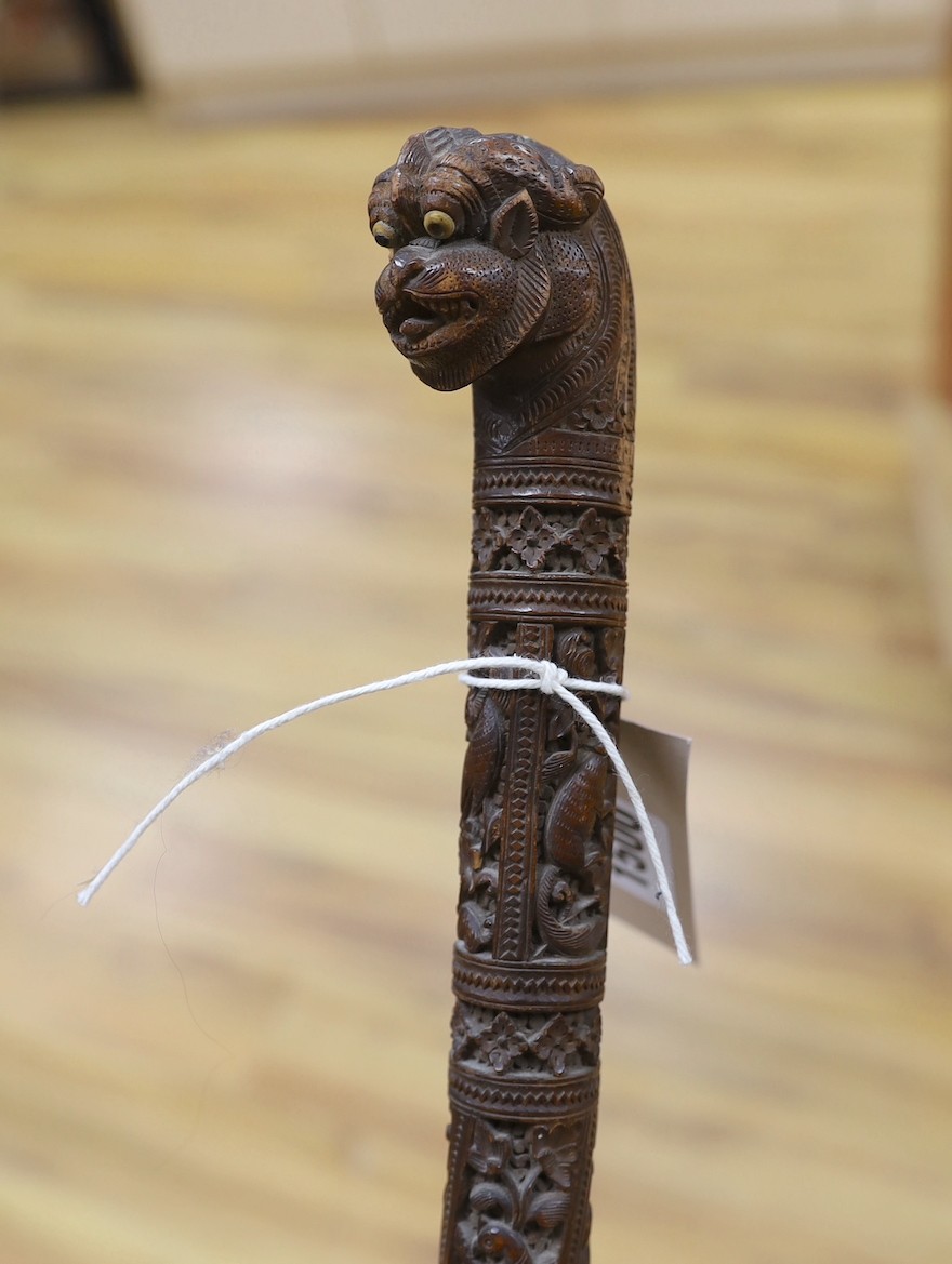 An Asian carved wood walking cane, 7 cm long.